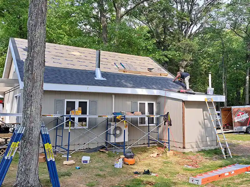 Crew installing new shingles